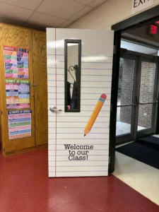 Classroom door wrapped as lined notebook paper with pencil graphic